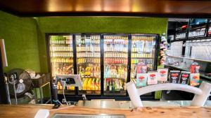 a store with a large cooler with drinks in it at Bounce Cairns in Cairns