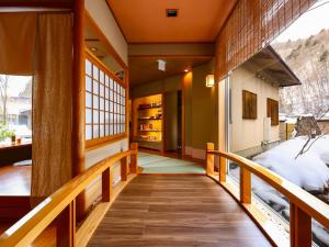 a hallway of a house with a wooden staircase at Keiryuso Siorie in Matsumoto +262 photos