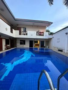 a large swimming pool with blue tiles in a building at Happy Valley Pattaya in Jomtien Beach