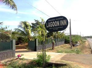 a sign for a lagoon inn on the side of a road at Lagoon Inn in Hambantota