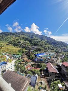a view of a town with a mountain in the background at 7th Heaven Lodge and Cafe in Banaue