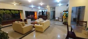 una sala de estar con sofás y mesas. en Hotel Celebes en Manado