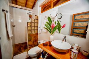 a bathroom with a sink and a toilet and a shower at Casa Portal de la Bodega in Mompos