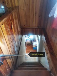 a stairway with a sign that reads wood stories at 7th Heaven Lodge and Cafe in Banaue