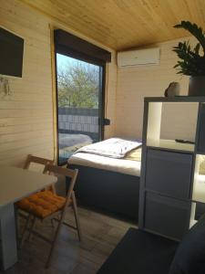 a small room with a bed and a window at Tiny House Birner Ertl in Ertl