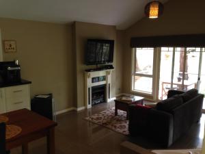 a living room with a couch and a fireplace at 3 Kings Bed and Breakfast in Yarra Junction