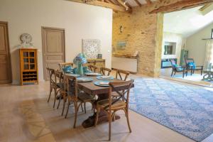a dining room with a table and chairs at Magnificent Guest House on the bank of the Dordogne river in Siorac-en-Périgord