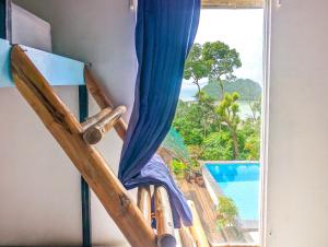 a room with a window with a view of a pool at Lexias Hostel and Workspace - El Nido in El Nido
