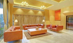 a living room with couches and a coffee table at Treebo Tryst Golden Bliss Trimurti Nagar Square in Nagpur