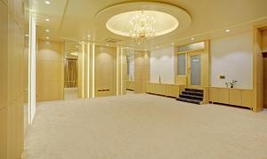 a large ballroom with a chandelier and a large room at Treebo Tryst Golden Bliss Trimurti Nagar Square in Nagpur