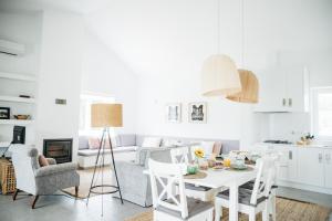 cocina y sala de estar con mesa blanca y sillas en Quinta De Guimaraes, en Miguas