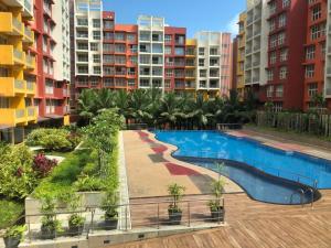 a swimming pool in a city with tall buildings at Nirvana Paraiso in Marmagao