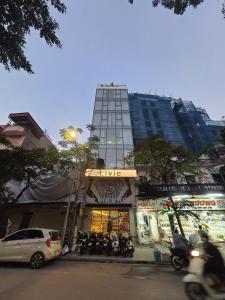 a tall building with a store in front of it at LIVIE Hanoi Ham Long in Hanoi