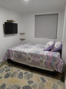 1 dormitorio con 1 cama y TV de pantalla plana en Envigado Parque Principal - Orquideas piso 3, en Envigado