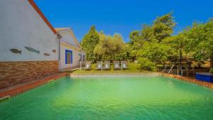 a swimming pool in the backyard of a house at Finca Real de Niebla by Ruralidays in Huelva