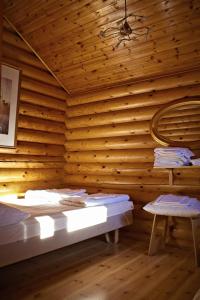 a room with a wooden wall with a bed and a chair at Rastila Camping Helsinki in Helsinki +27 photos