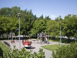a park with a playground with a swing set at Rastila Camping Helsinki in Helsinki