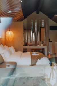 a bedroom with a large bed and a swimming pool at Comme chez Soye - Private Wellness in Soye