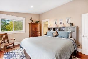 a bedroom with a bed and a chair and a window at The Lighthouse in La Conner