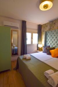 a bedroom with a large bed and a window at Letmalaga Square Merced in Málaga