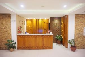 a lobby with a wooden bar in a building at Kautaman Hotel in Mataram