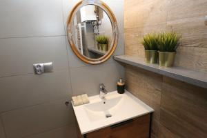 a bathroom with a sink and a mirror at Old Gdansk No 8 in Gdańsk