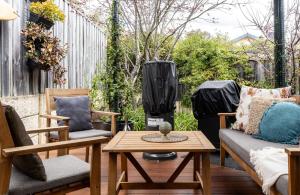 a patio with two chairs and a table at Lime Tree Haven in Margaret River Town