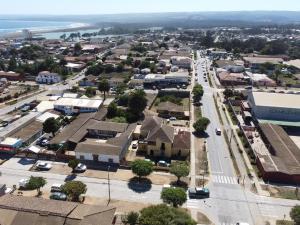 an aerial view of a small town with a street at Hostal Kuyen in Pichilemu
