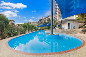 LarrakeyahにあるCullen Bay Penthouse with Pool, Decks and Marina Viewsの建物前の青い水のプール