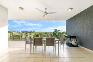 a dining room with a table and chairs at 'Pearl Paradise' A Tropical Oasis with Ocean Views in Darwin