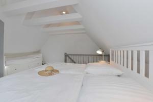 a bedroom with two beds with a hat on it at STöRTEBEKER APPARTEMENTS - "BLAUES HAUS" in Ralswiek