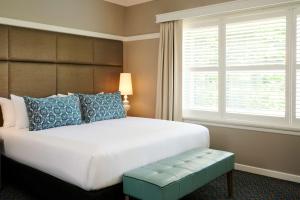 a bedroom with a large bed and a window at Hotel Kurrajong Canberra in Canberra