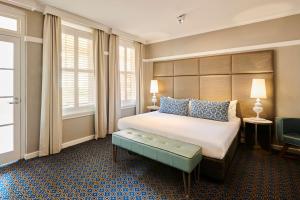 a hotel room with a bed and a window at Hotel Kurrajong Canberra in Canberra