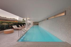 a swimming pool in the middle of a building at Adina Apartment Hotel Bondi Beach Sydney in Sydney