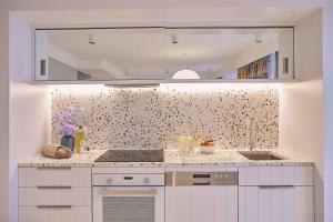 a kitchen with a sink and a counter top at Adina Apartment Hotel Chippendale in Sydney