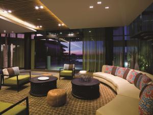 a living room filled with furniture and a large window at Adina Apartment Hotel Darwin Waterfront in Darwin
