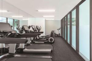 a gym with treadmills and elliptical machines at Vibe Hotel Darwin Waterfront in Darwin