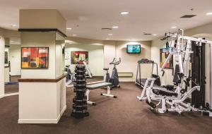 a gym with treadmills and machines in a room at Travelodge Hotel Wellington in Wellington