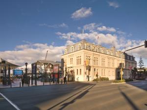 a large white building on a city street at Travelodge Hotel Wellington in Wellington