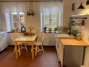 a kitchen with a table and chairs and a sink at Gartenhaus - a68978 