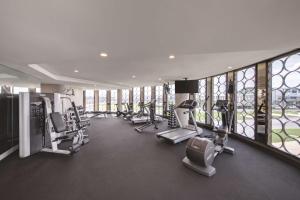 a gym with treadmills and ellipticals in a building at Vibe Hotel Canberra in Canberra