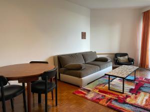 a living room with a couch and a table and chairs at Locarno: Casa Lido in Locarno