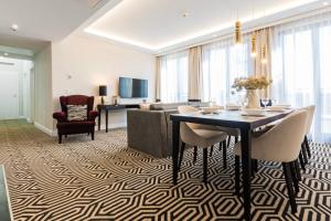 a living room with a table and a couch at VacationClub - Baltic Park Fort Apartament G.508 in Świnoujście