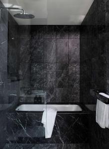 a bathroom with a sink and a bath tub at A by Adina Sydney in Sydney
