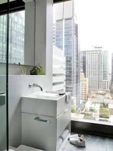 a bathroom with a sink and a large window at A by Adina Sydney in Sydney