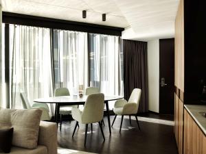 a dining room with a table and chairs at A by Adina Canberra in Canberra