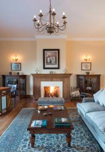 a living room with a couch and a fireplace at Ceylon Tea Trails in Hatton