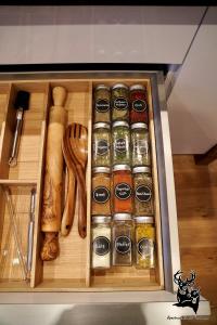 a drawer filled with spices and wooden utensils at Apartment-Chalet Panorama in Todtmoos