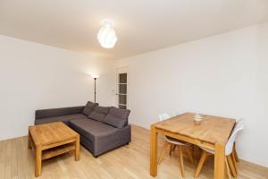 a living room with a couch and a table at Large apartment near Bois de Vincennes in Charenton-le-Pont