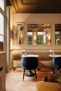 a dining room with a table and a couch at Hotel 717 in Amsterdam